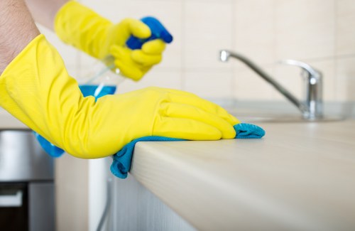 Technician performing steam carpet cleaning in a hallway