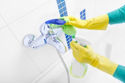 Cleaner using protective gloves during carpet cleaning